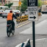Cyclist riding safely beside cars in an urban bike lane